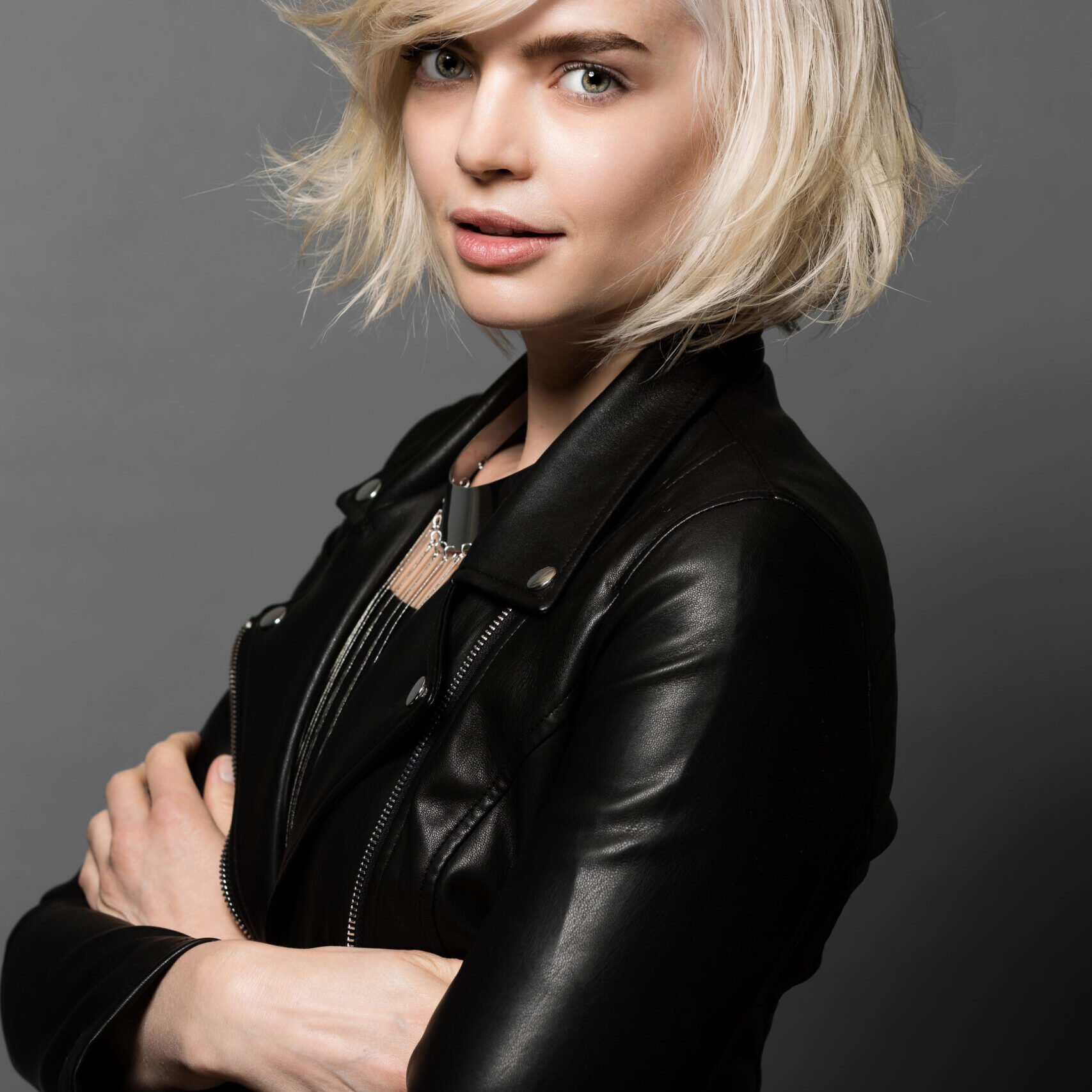 Blonde woman in black leather jacket.